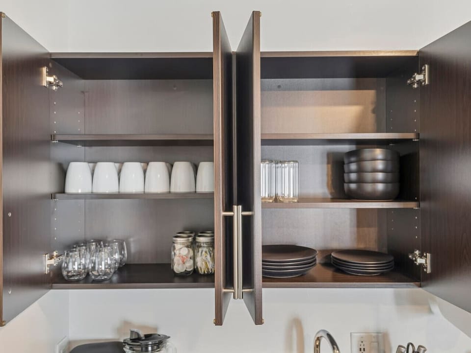 Cabinets stocked with glasses, mugs, and dinnerware 🍽️☕🥂—everything you need for meals, coffee, or a relaxing drink!