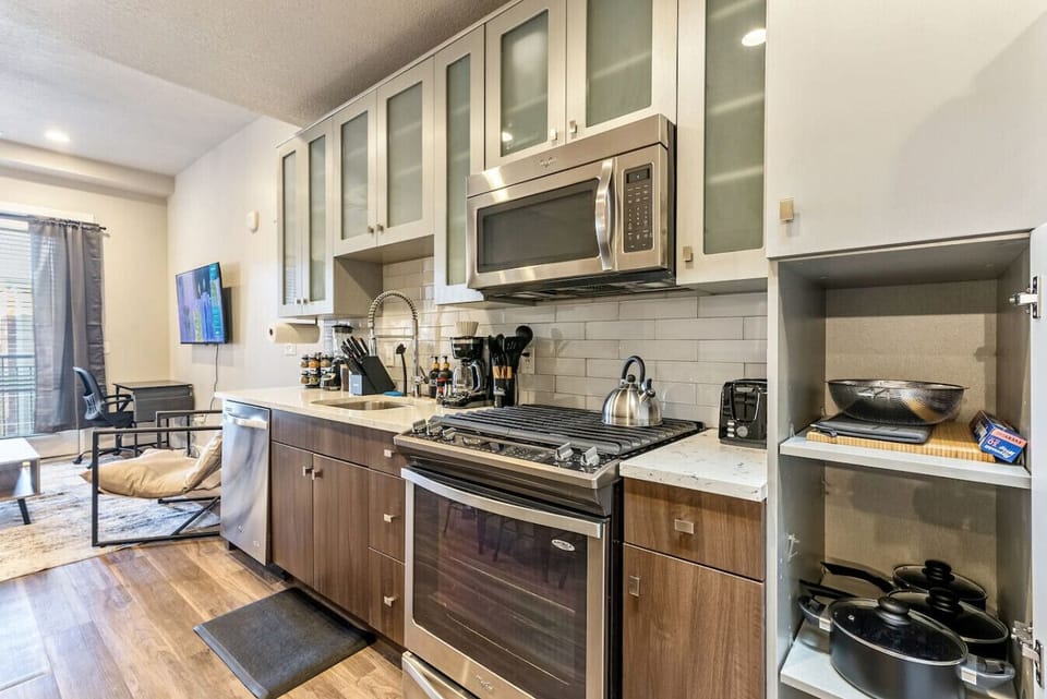 Modern kitchen w/ stainless appliances, sleek cabinets & everything set for easy cooking