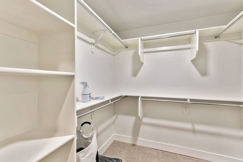 Spacious walk-in closet w/ shelving & hanging space to keep everything organized