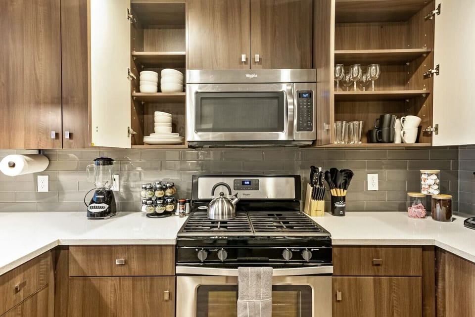 Functional kitchen w/ stove, microwave & ample cabinetry for cooking at home