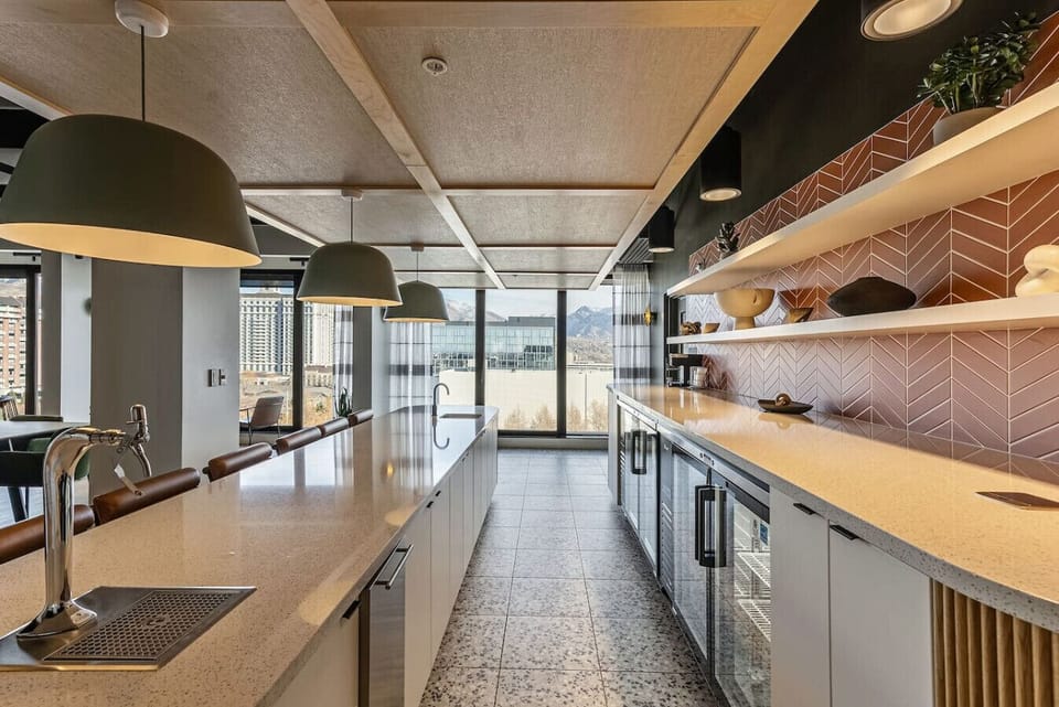 Sleek kitchen with polished countertops, modern shelving, and expansive windows bringing in mountain scenery 🌄🍴