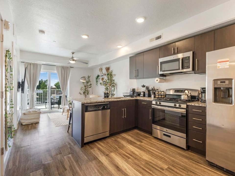 Cook 🍳, relax 🛋️, and enjoy the sunshine ☀️ in this stylish open-concept kitchen + living space!