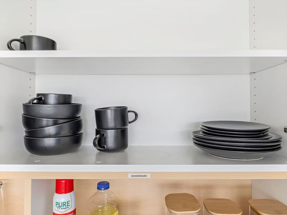 Enjoy your meals with stylish dishware and mugs neatly stocked for your comfort 🍽️☕