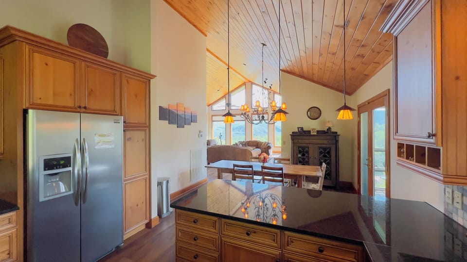 Fully equipped kitchen with stainless appliances and extra seating. 