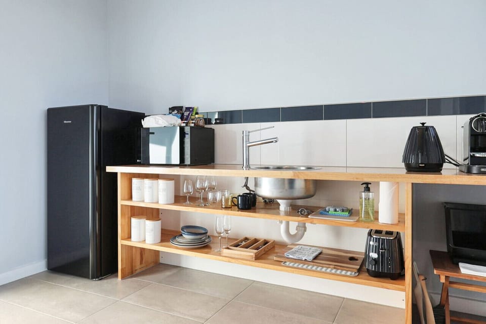 Fully equipped kitchenette with fridge, microwave, and essentials