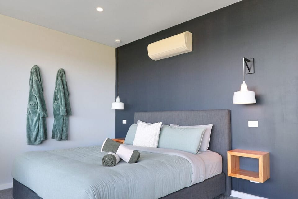 Stylish bedroom with plush bedding, soft tones and modern finishes