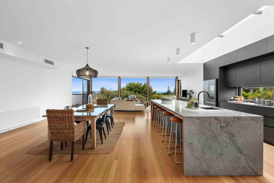Open-plan kitchen and dining with large island and seating