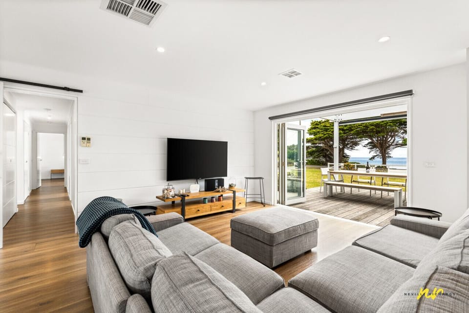 Bright open living area with indoor-outdoor flow and relaxed seating
