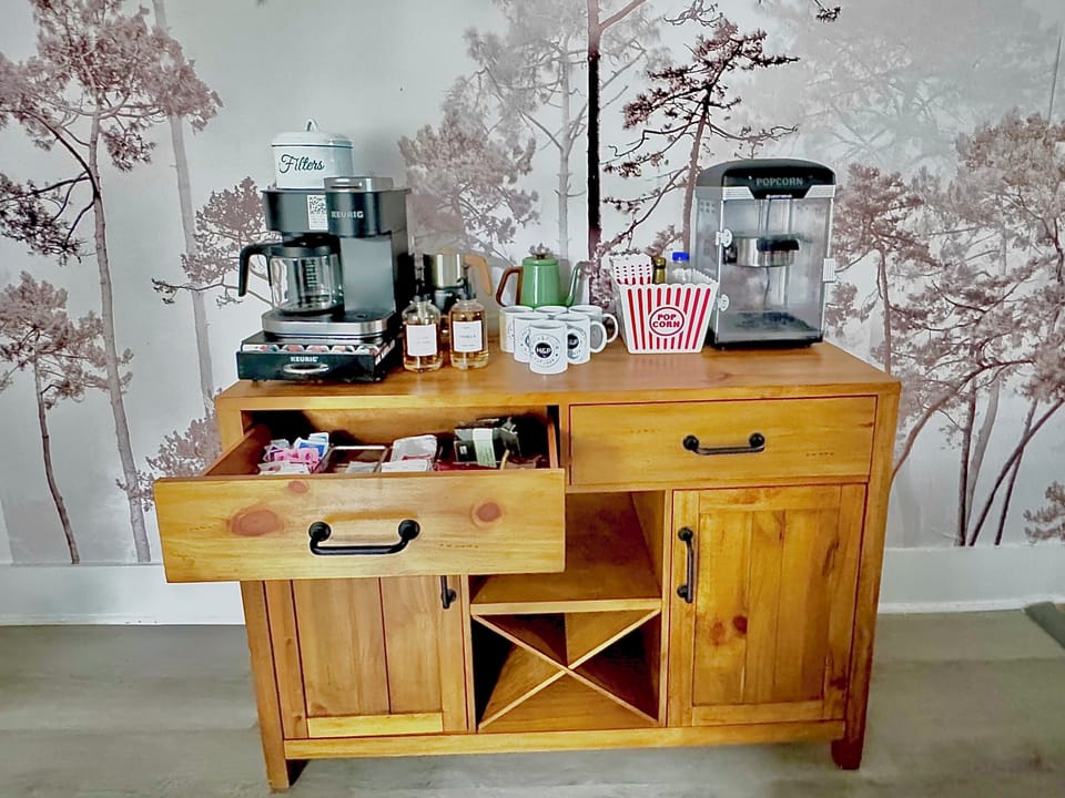 Full coffee bar, includes a coffee machine that can either brew one cup or coffee for everyone, Electric tea pot, Milk Frother that will heat milk for coffee or hot chocolate.