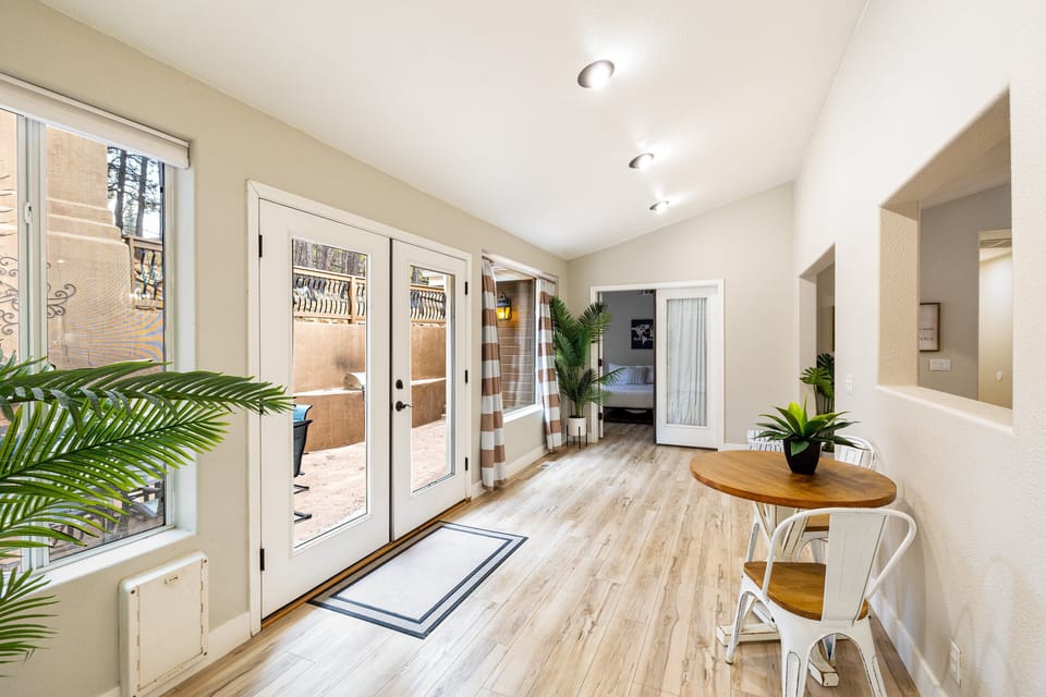 A cozy sunroom with serene patio views, perfect for enjoying the outdoors in any weather.
