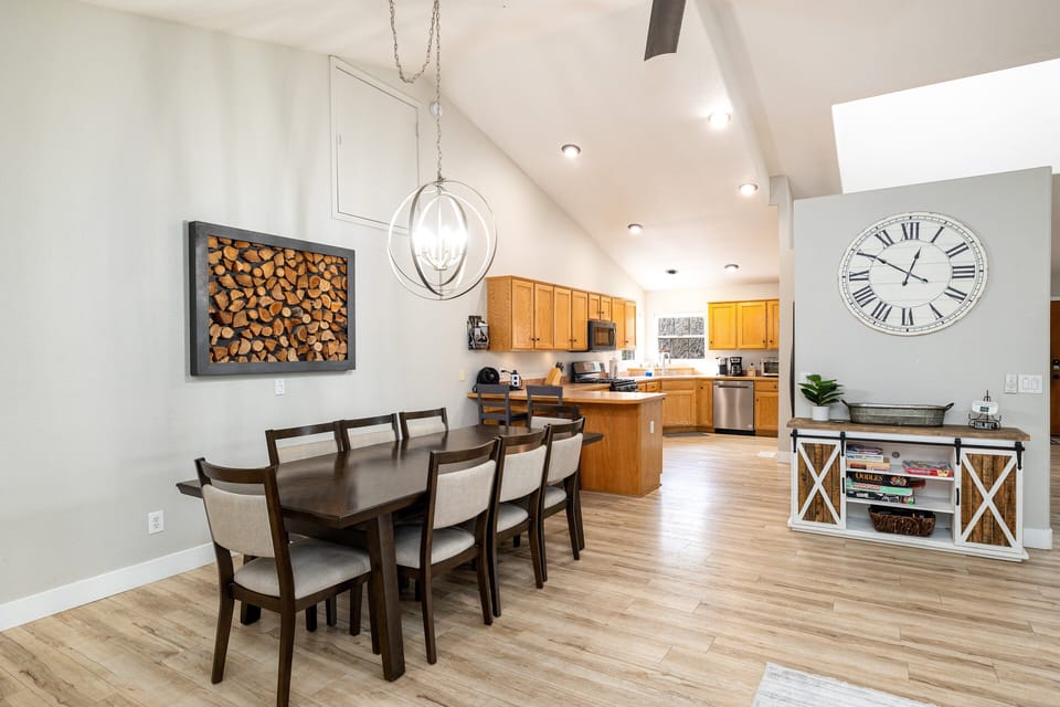Spacious dining area with a table for 8 and additional 2 seats at the kitchen counter.