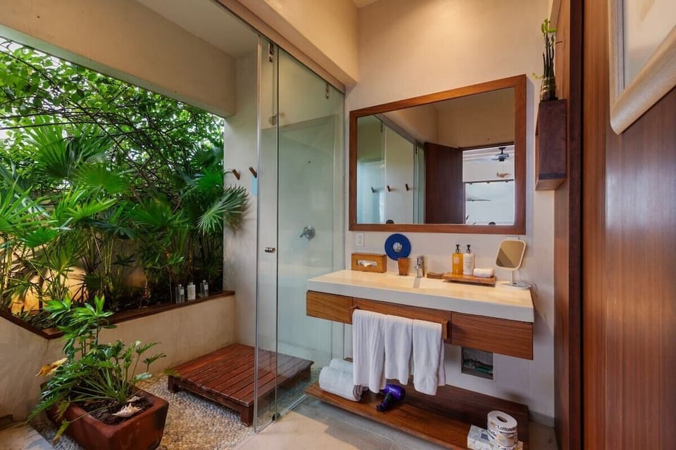 Enjoy a spa-like experience in this open-concept bathroom, blending natural elements with modern luxury.