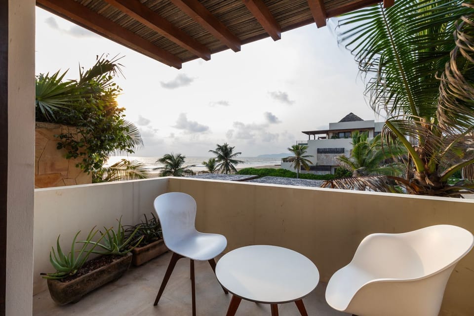 Unwind on this beautifully designed terrace, offering comfortable seating, lush greenery, and stunning beach views.