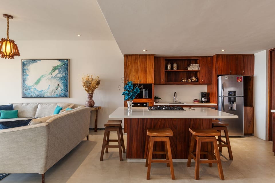 A sleek, well-equipped kitchen featuring handcrafted wood cabinetry, a spacious countertop, and high-end appliances.