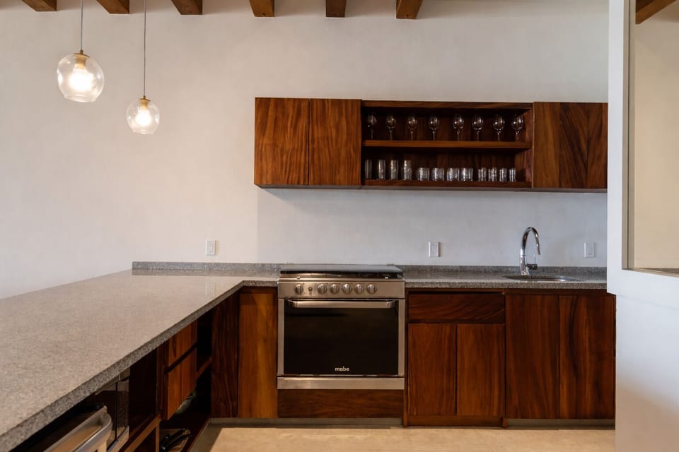 A contemporary kitchen with elegant wood finishes, modern appliances, and a clean, functional design.