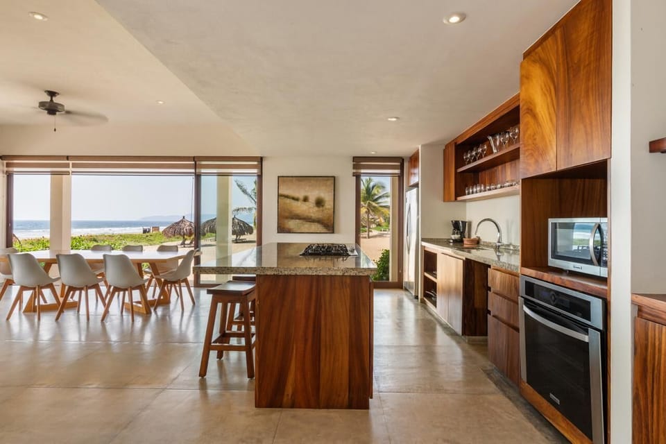 A fully equipped kitchen featuring premium appliances, elegant wood cabinetry, and a spacious island for entertaining.