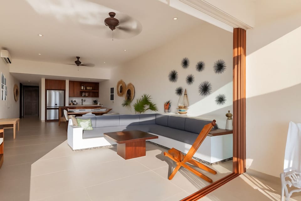 Cozy yet modern living space with ample seating, large windows, and tropical views for a refreshing stay.