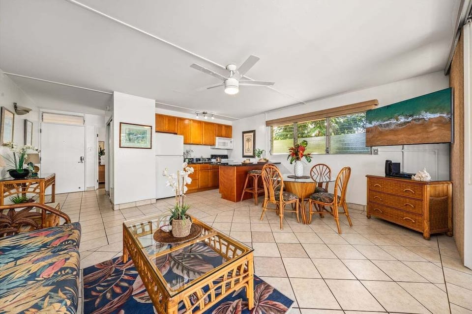 Spacious living room with sleeper sofa, dining area, and open kitchen layout.