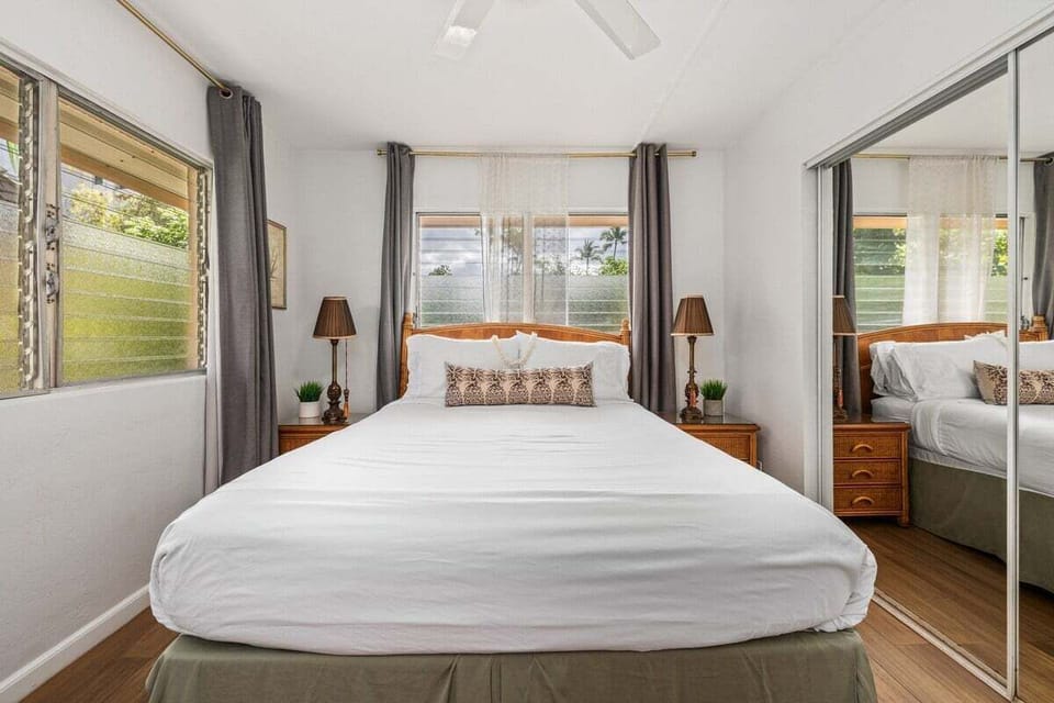 Peaceful bedroom featuring a queen bed and bright window views.