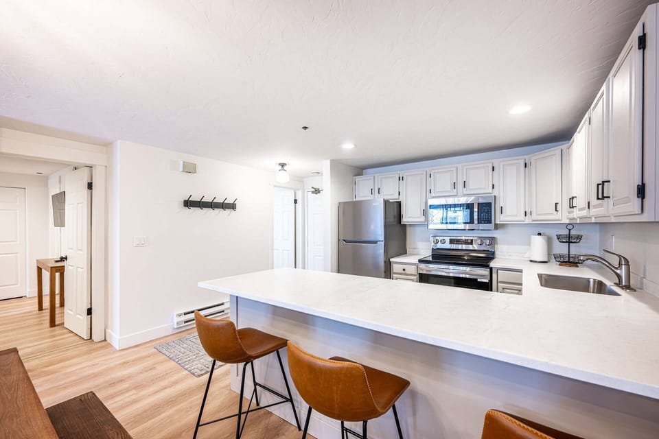 Fully equipped kitchen with full sized, stainless steel appliances and ample counter space.
