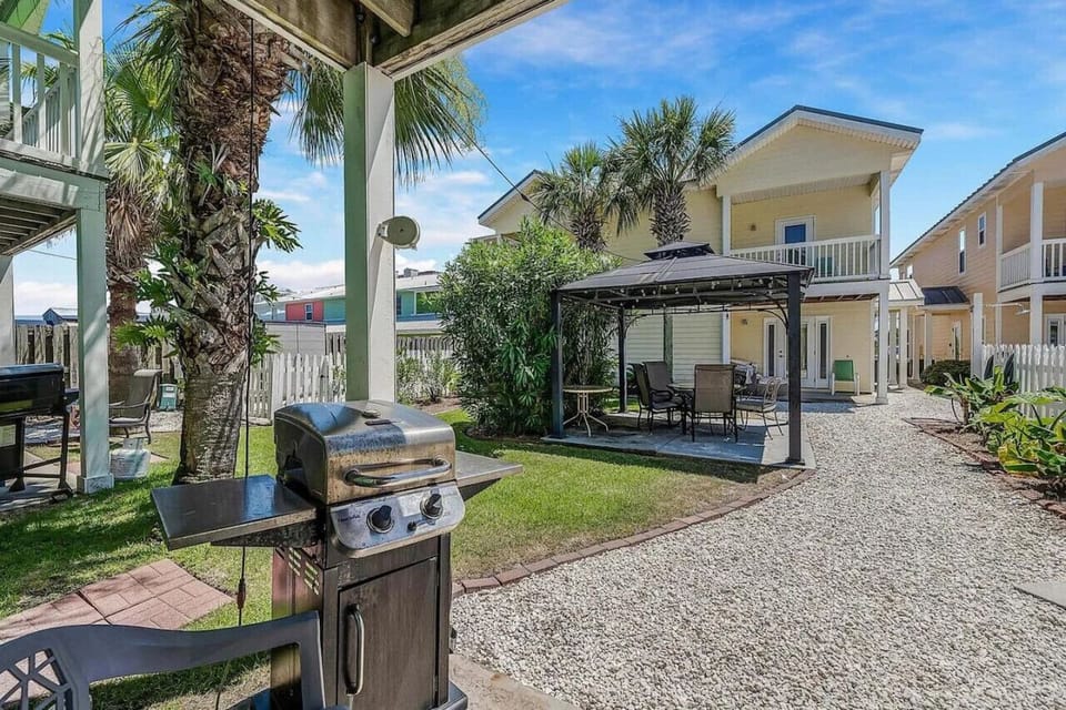 A covered gas grill area with a charming gazebo, creating the perfect spot for outdoor cooking and dining in a cozy, shaded setting!