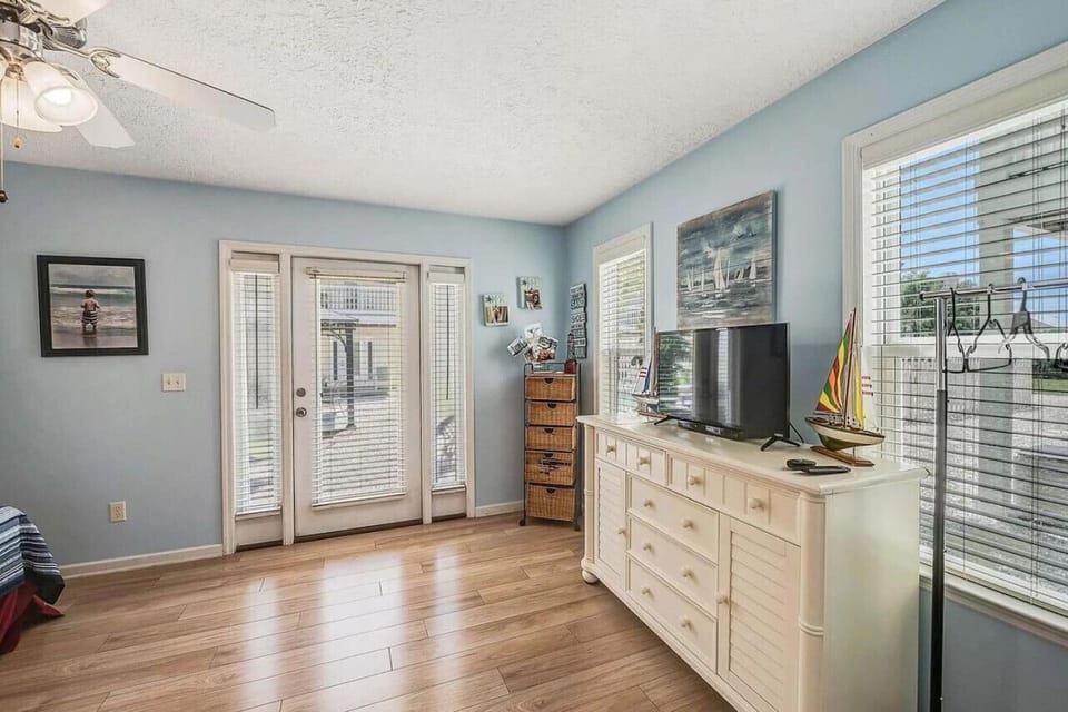 A spacious king bed with a TV and outside access offering the ultimate comfort and convenience for a relaxing retreat!