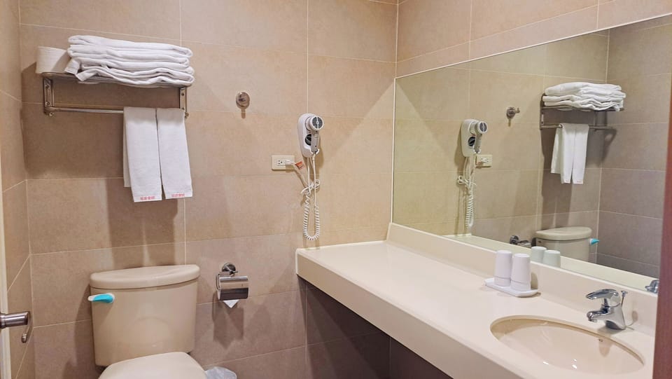 Shower, hair dryer, slippers, towels