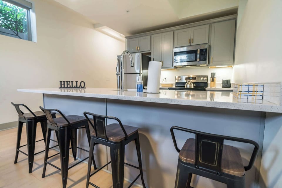 Enjoy a spacious, modern kitchen with a large island and bar seating, perfect for cooking or gathering.