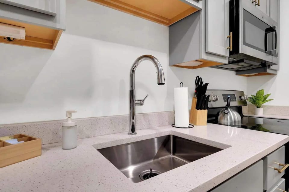Kitchen: Modern kitchen with sleek stainless-steel appliances and ample counter space.