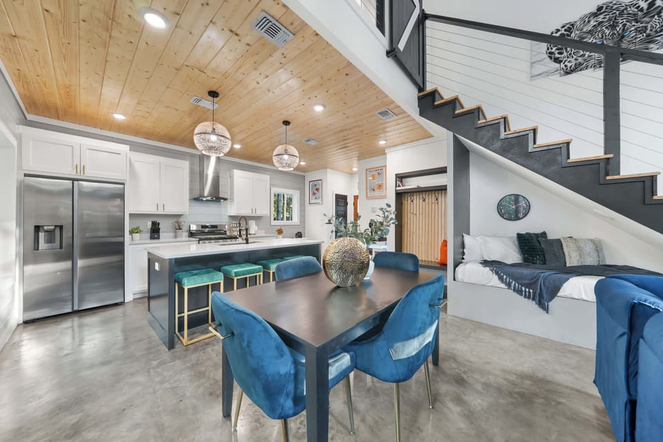 The dining table seats up to 4 guests, with 4 additional seating arrangements available on the island barstools.