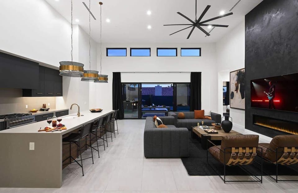 Open-concept living area featuring designer furnishings, a Smart TV, and fireplace