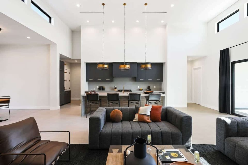 Open-concept living area featuring designer furnishings, a Smart TV, and fireplace