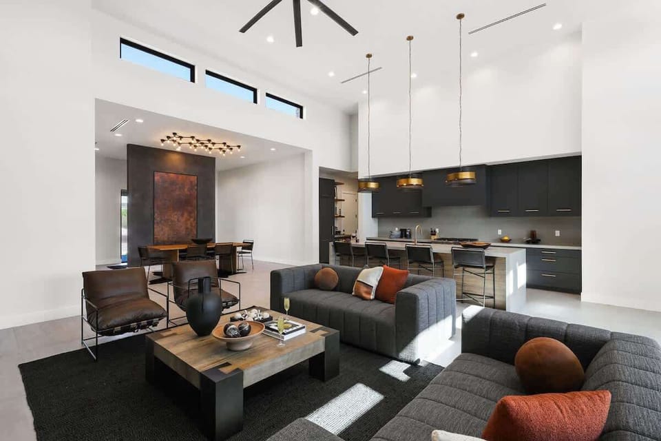 Open-concept living area featuring designer furnishings, a Smart TV, and fireplace