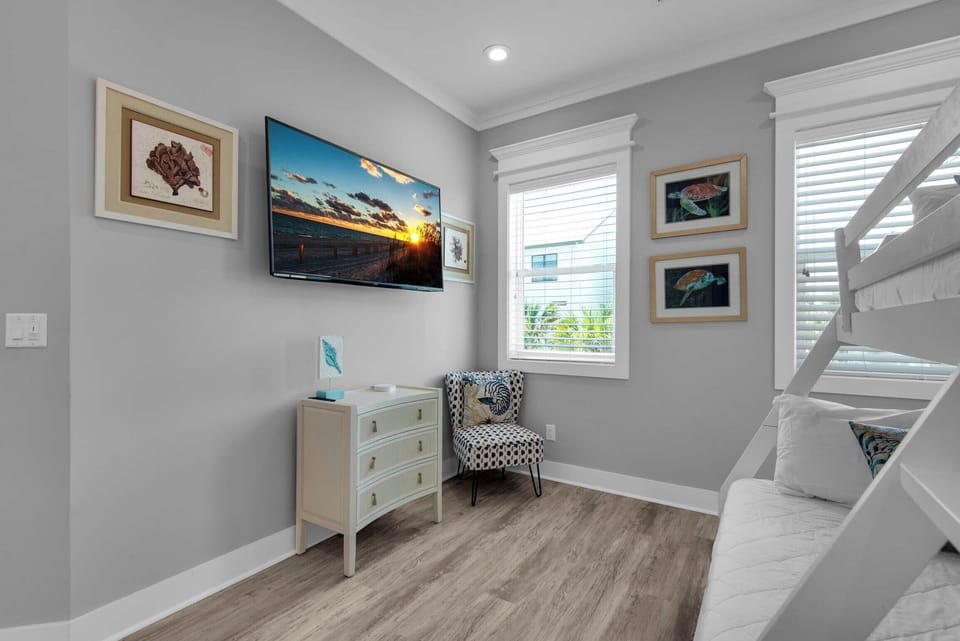 Second floor bunk room with a large flat-screen TV