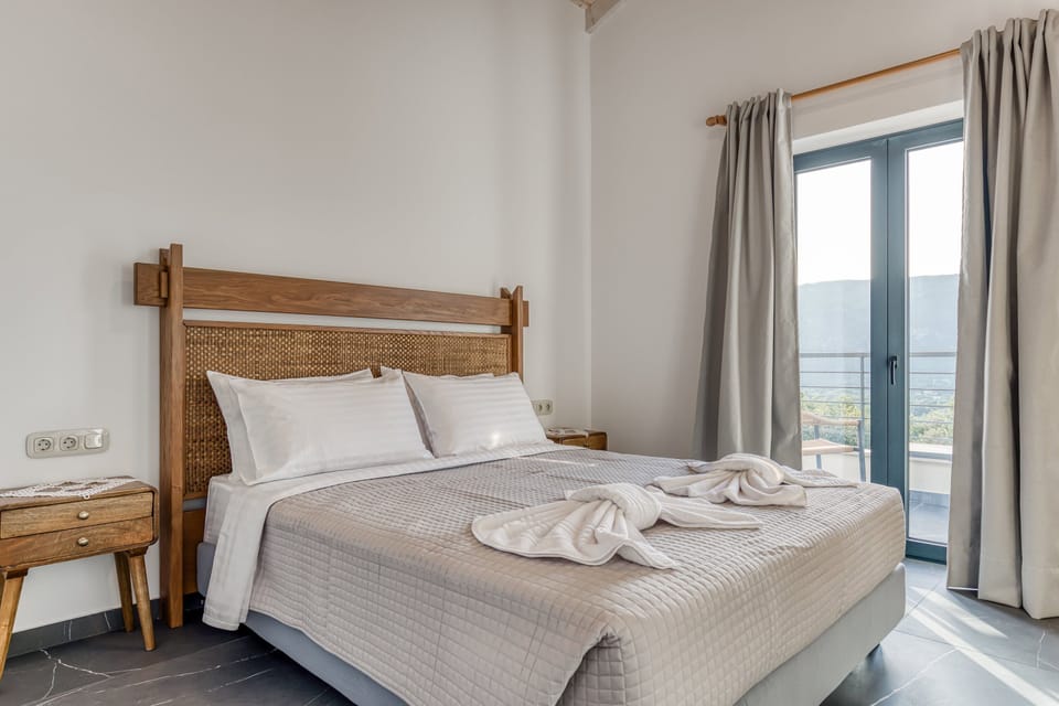"Rest easy in this spacious bedroom, featuring high ceilings and elegant furnishings."