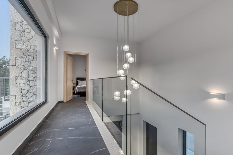 "Experience modern elegance in our villa's hallway, featuring stylish decor and ample natural light."