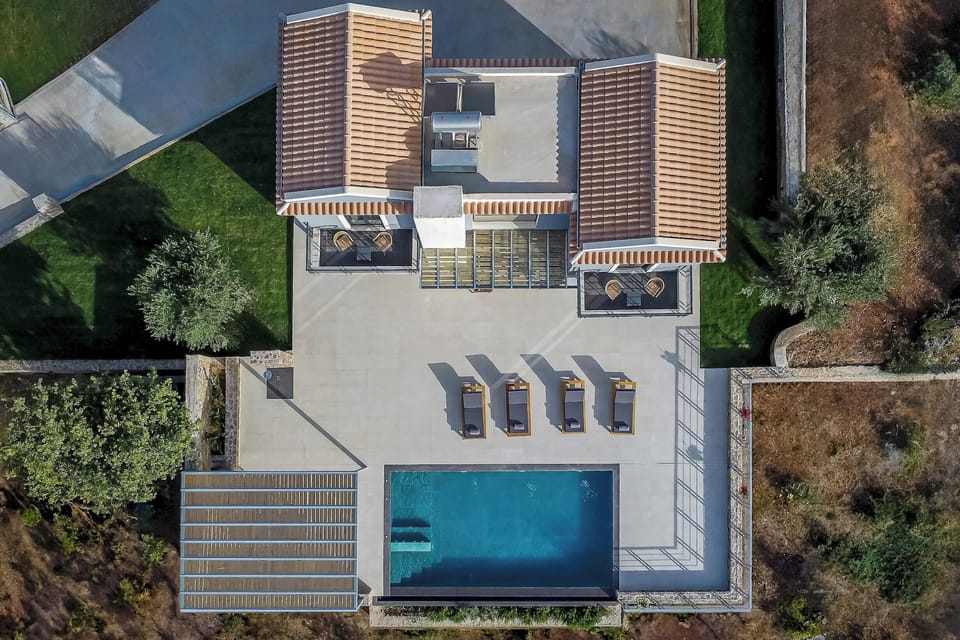 "Luxurious villa with infinity pool and ample lounging space."