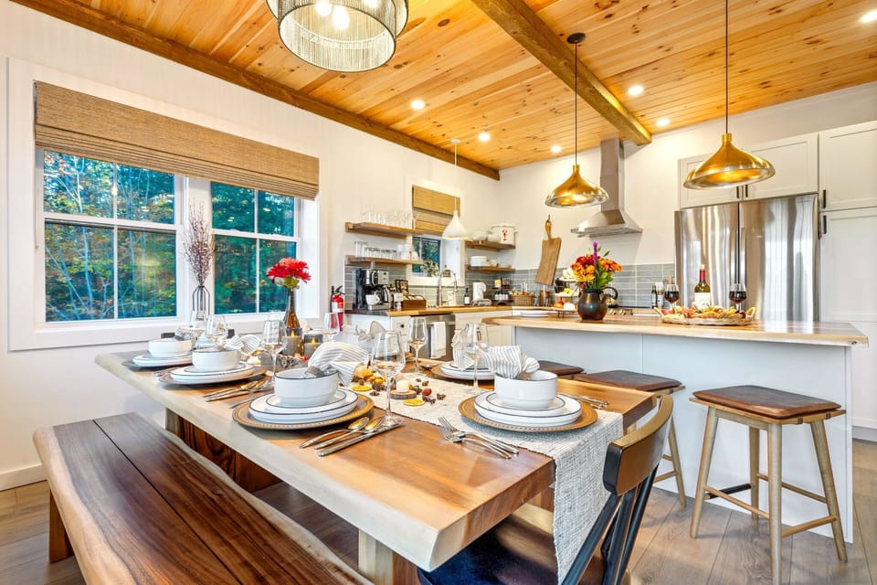 A cozy dining spot with all the essentials and a forest view.