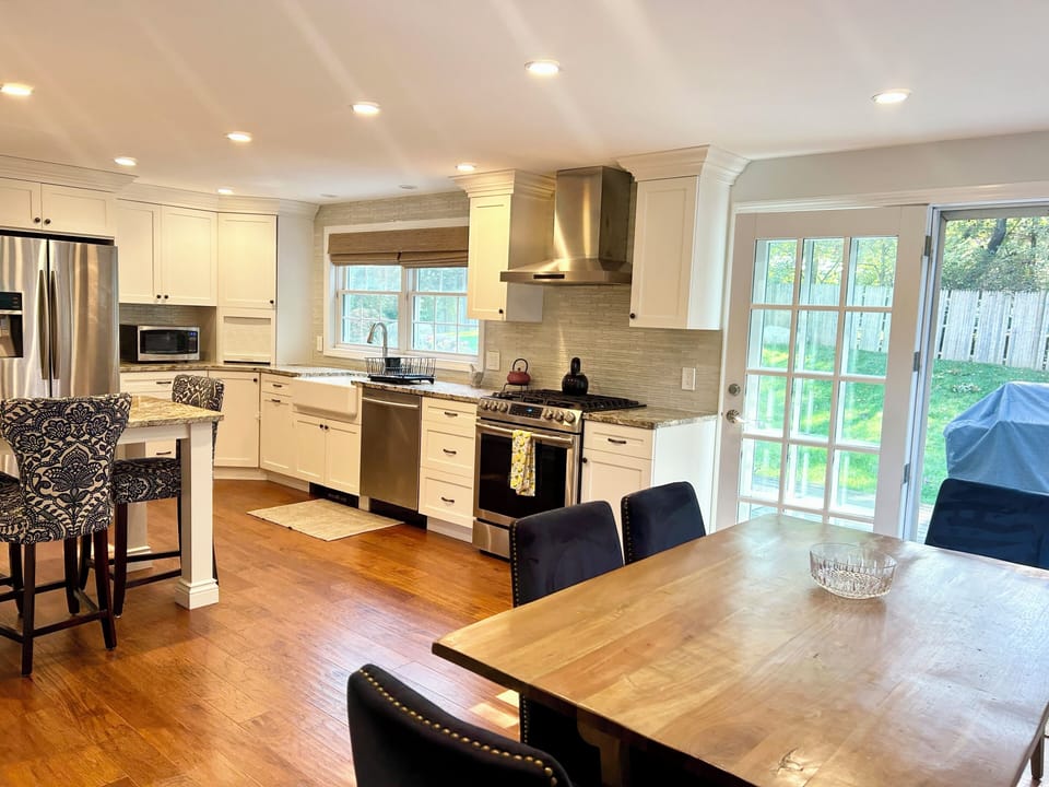 Kitchen looks out to back deck and fully fenced in private backyard