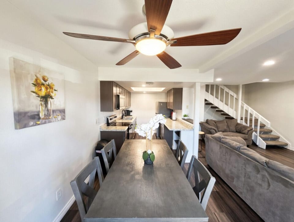 Spacious dining table seats everyone with stylish fan overhead