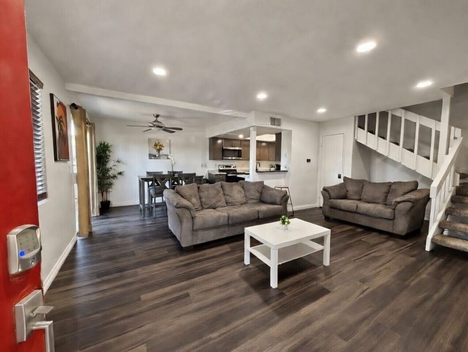 Cozy spacious living area with comfy seating and tall ceilings