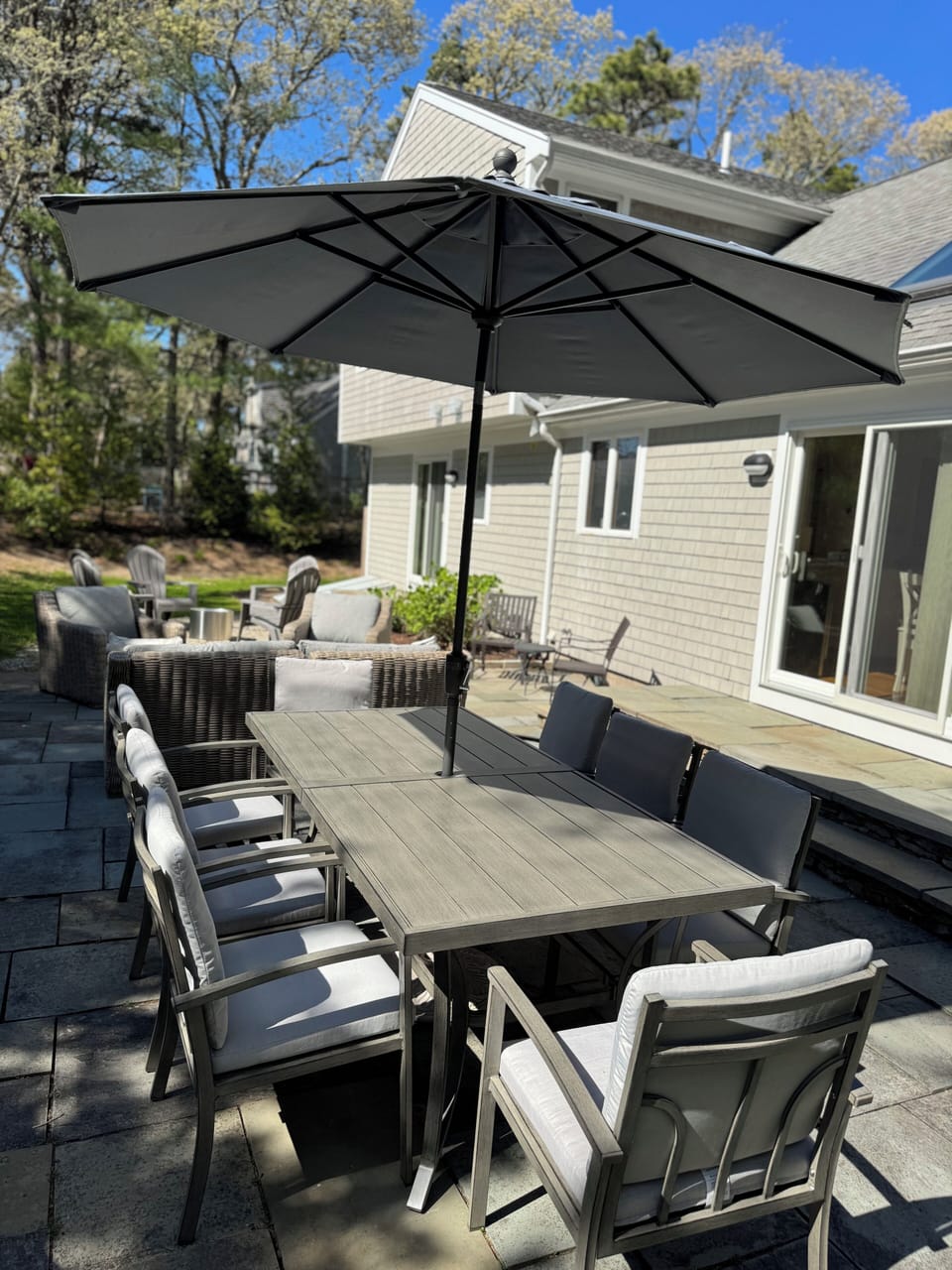Backyard Patio - 8 person dinning table, 6 person sofa and 6 person fire pit