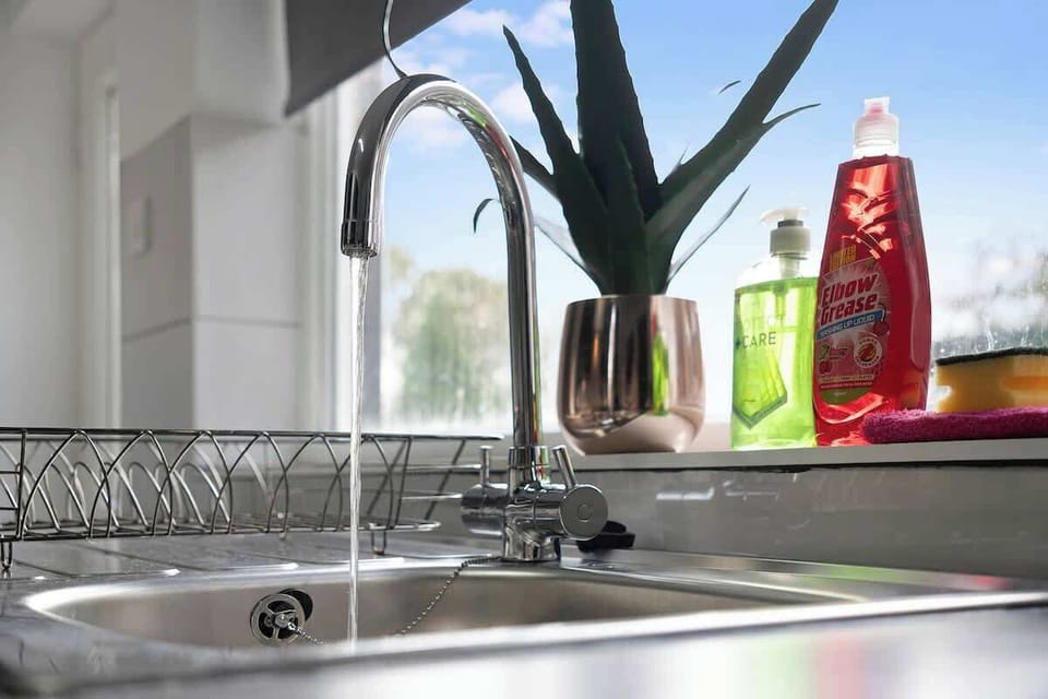 Kitchen equipped with all essentials, including a washer & dryer, oven, fridge and full cookware set.