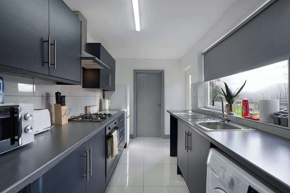 Kitchen equipped with all essentials, including a washer & dryer, oven, fridge and full cookware set.