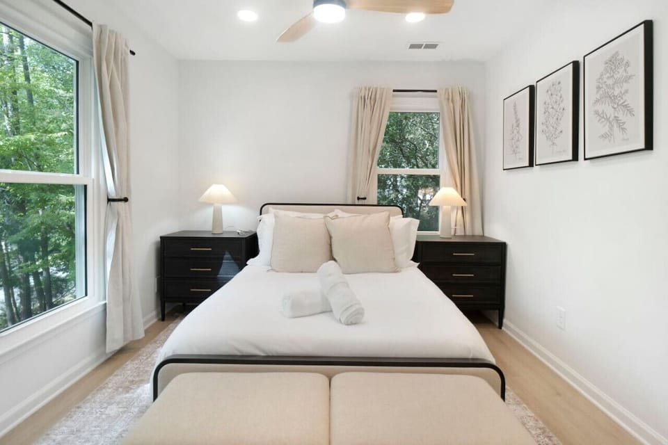 Comfortable bedroom w/ soft bedding, natural light, and a calm, uncluttered feel.