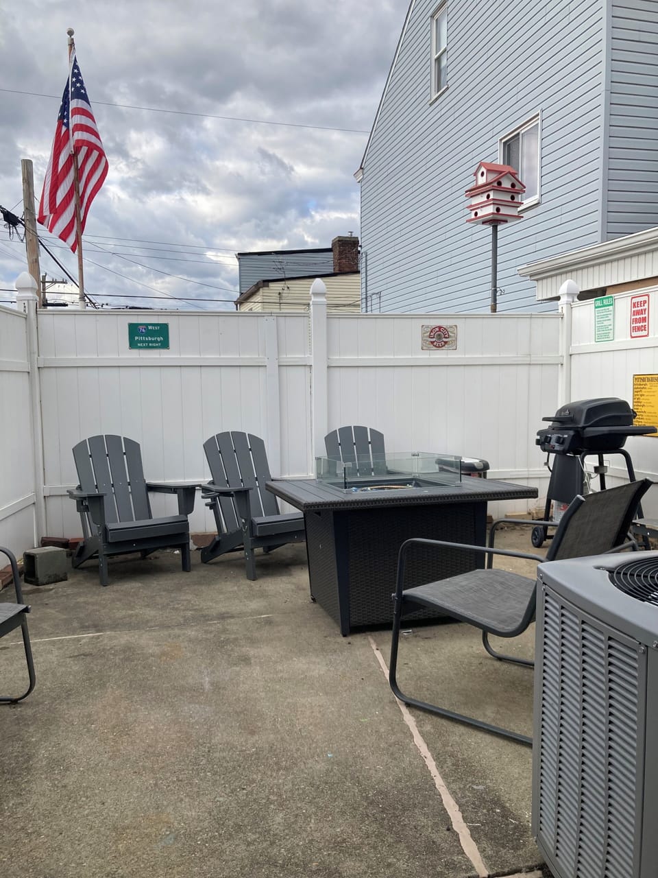 Outdoor patio with outdoor furniture, grill, firepit, chairs, & privacy fence!