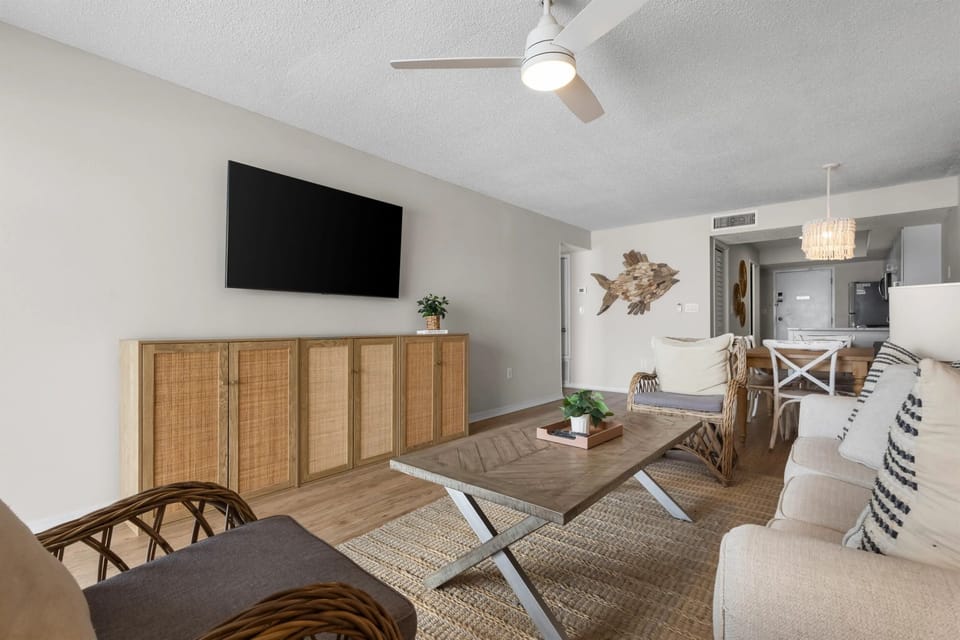  Living room with a smart TV, cozy seating, and stylish décor, offering a perfect space for relaxation and entertainment.