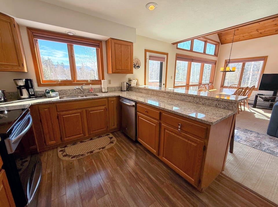 Main level kitchen area with granite countertop.