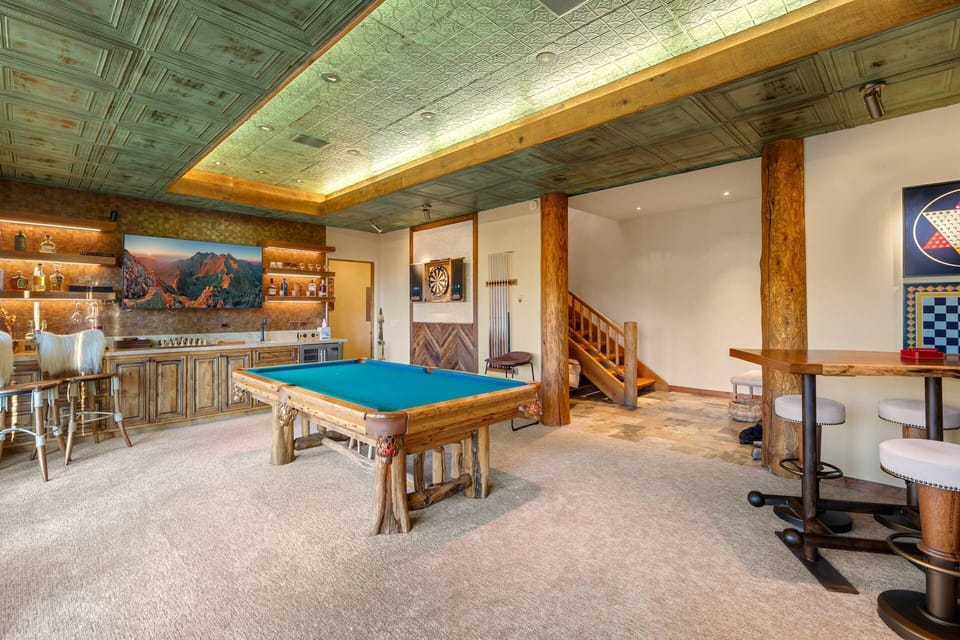 Wet bar and large smart TV in the game room