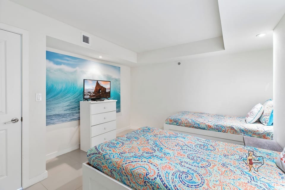 Bedroom 3 - Inviting guest room featuring a bright, patterned bedspread and soft lighting.